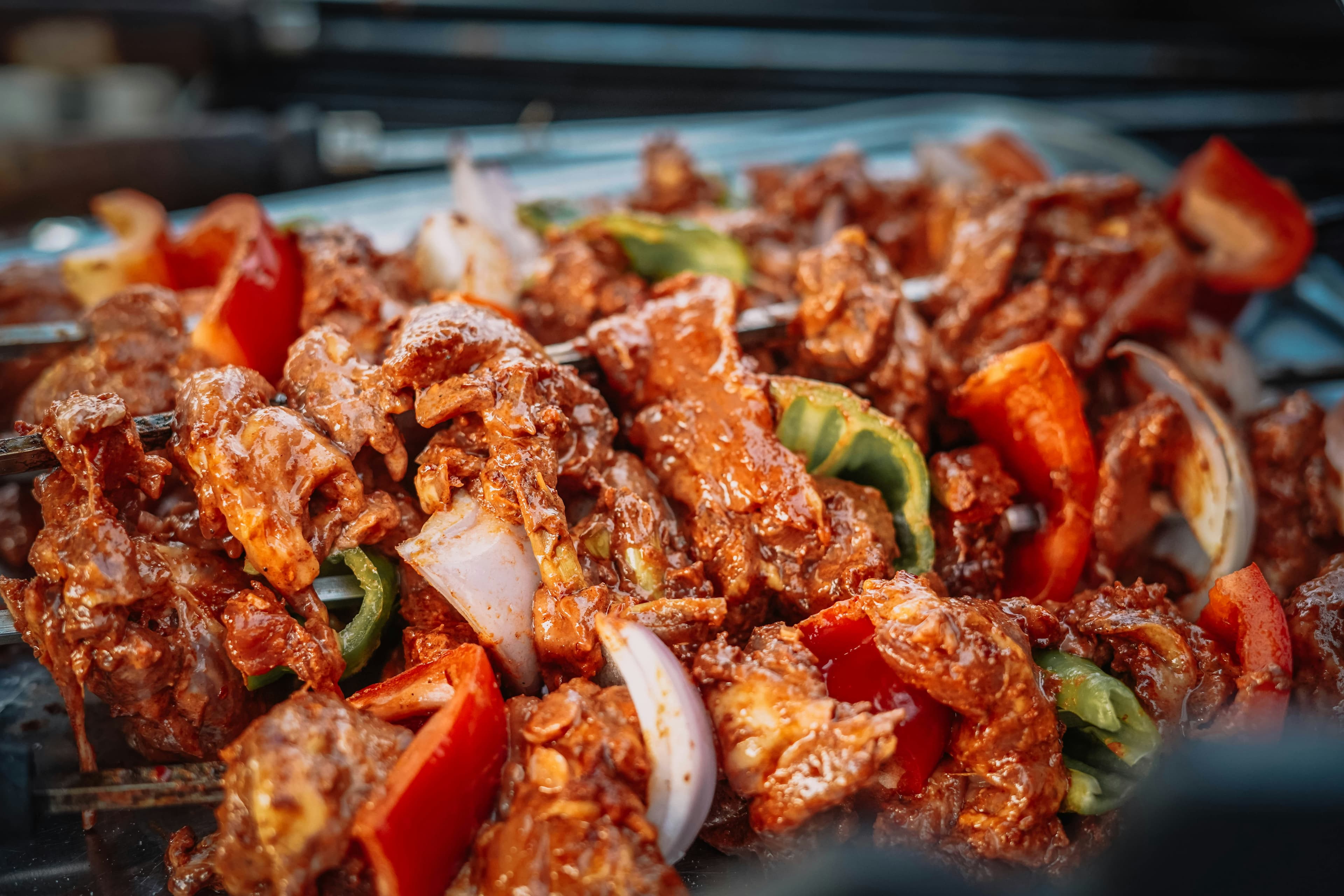 Marinated pork skewers with peppers and onions on the grill